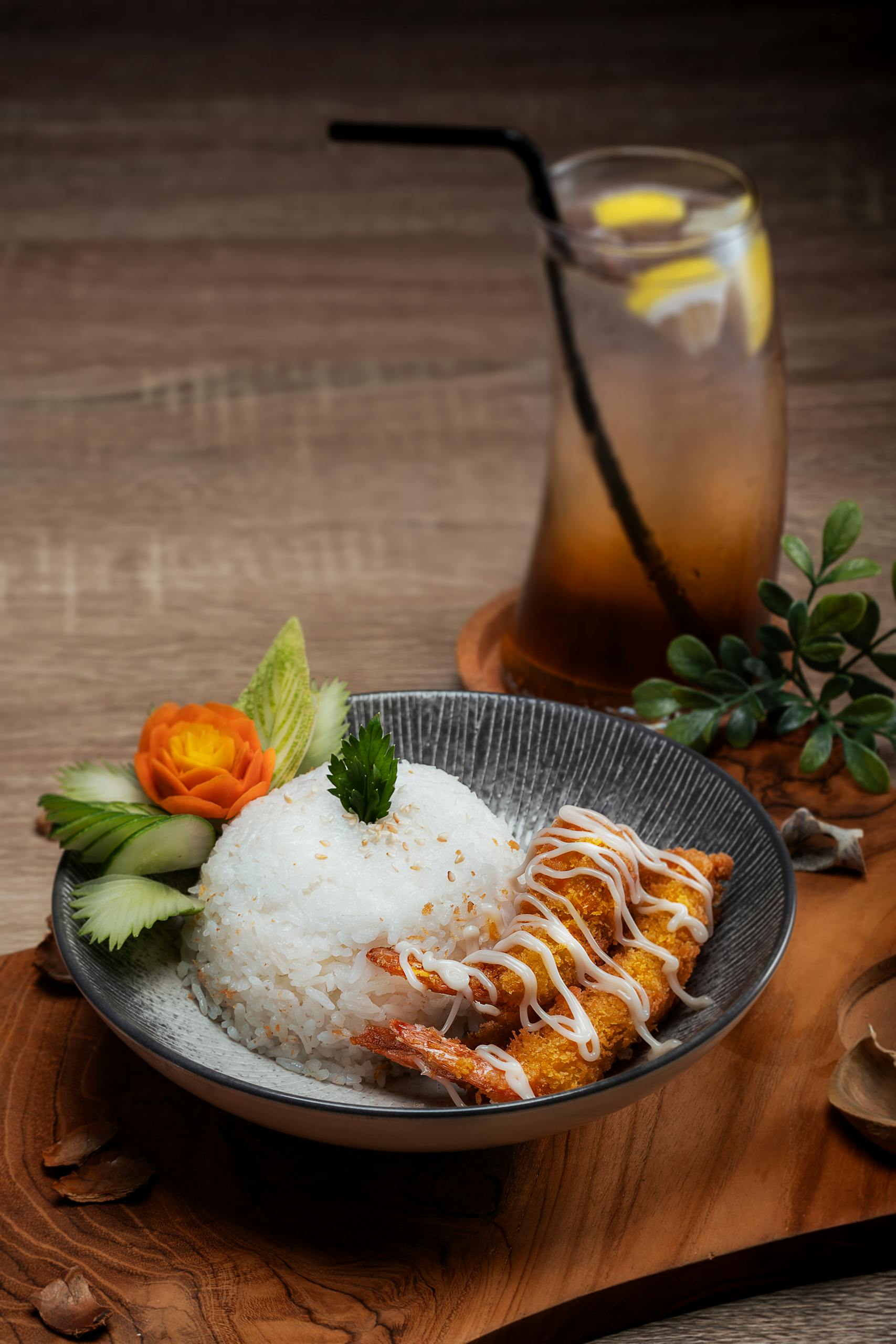 Delicious Japanese tempura shrimp with rice and garnish served in a bowl, perfect for food photography.